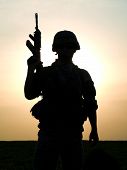 image of silhouette  - Silhouette of US soldier with rifle against a sunset - JPG 