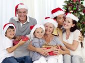 pic of family  - Family in sofa giving presents for Christmas - JPG 
