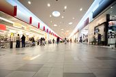 stock photo of trade  - Wide hall and buyers in trading center with shops on both sides - JPG 