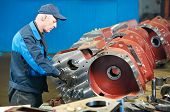 pic of industrial  - adult experienced industrial worker during heavy industry machinery assembling on production line manufacturing workshop - JPG 