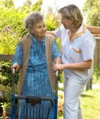picture of nurse  - Senior woman walking with the help of her nurse - JPG 
