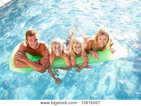 Picture or Photo of Family Outside Relaxing In Swimming Pool