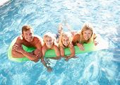 pic of family  - Family Outside Relaxing In Swimming Pool - JPG 