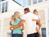 image of home  - Young Family Standing Outside Dream Home - JPG 