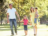 stock photo of walking  - Family Enjoying Walk In Park - JPG 