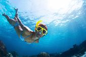 stock photo of lady  - Underwater shoot of a young lady snorkeling and doing skin diving in a tropical sea - JPG 