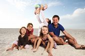 pic of beach  - Beautiful family enjoying sunny day at the beach - JPG 