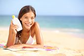 pic of woman  - Sunscreen woman showing suntan lotion bottle - JPG 