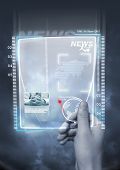 picture of future technology  - A concept of future technology with a man holding a electronic newspaper - JPG 