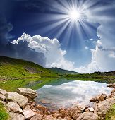 stock photo of calm  - Beautiful mountains landscape over a calm lake - JPG 
