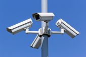 picture of security  - four security cameras in front of blue sky - JPG 