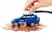 pic of stethoscope  - Toy car with a stethoscope on top of stacks of coins - JPG 